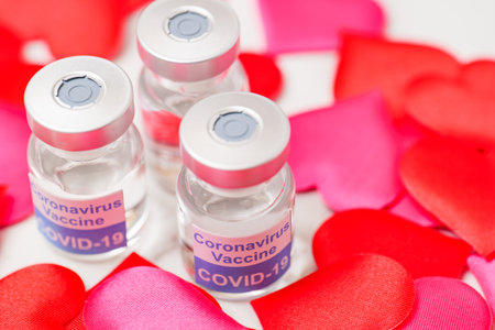 Image of the new corona vaccine surrounded by hearts