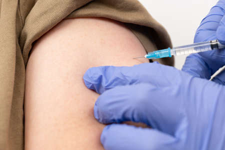 a middle-old woman who is given an injectionの写真素材