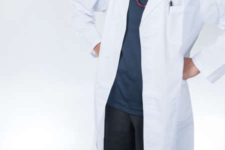 Male doctor in lab coat, hands on hipsの写真素材