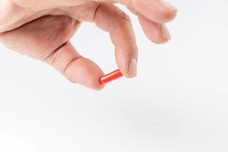 a man's hand having a capsule-like drinking pillの写真素材