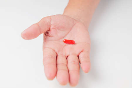a capsule-like drinking drug in the palm of a man's handの写真素材