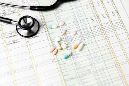 Health checkup results and stethoscopes and medicationsの写真素材