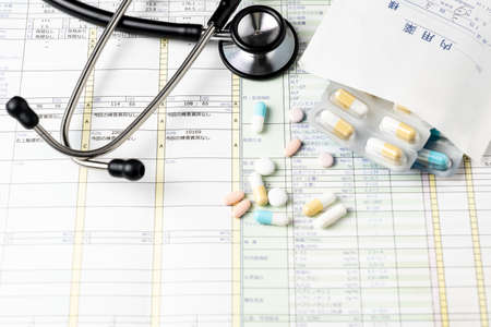 Health checkup results and stethoscopes and medicationsの写真素材
