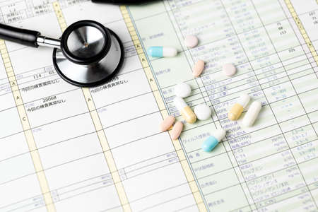Health checkup results and stethoscopes and medicationsの写真素材