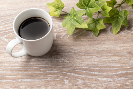 Coffee and plants with wood grain backgroundの写真素材