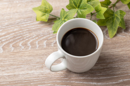 Coffee and plants with wood grain backgroundの写真素材
