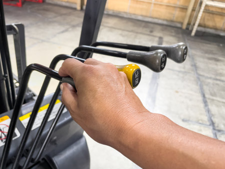 Male hand operating the forklift leverの写真素材