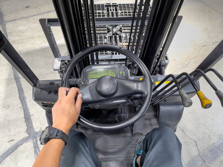 Male hand operating the handle of a forkliftの写真素材