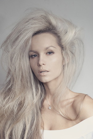 Fashionable portrait of a dark and sexy girl with tousled hairの写真素材