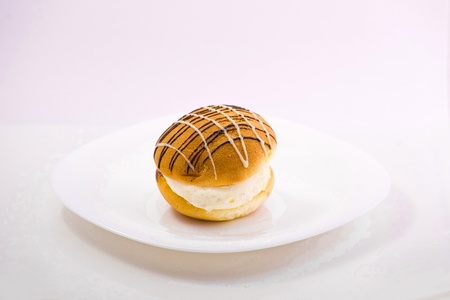 sweet cake on the plate isolated over white backgroudの写真素材