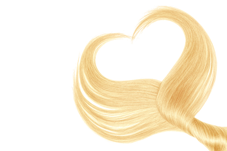 Blond hair in shape of heart, isolated on white backgroundの写真素材
