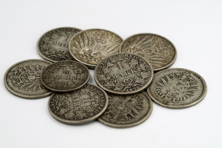 heap of old coin from german empire isolated on white backgroundの写真素材