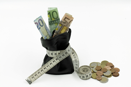 constricted purse with euro banknotes and coins isolated on white backgroundの写真素材