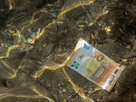 close up of fifty euro banknote on sea bottom with reflections, money is underwaterの写真素材