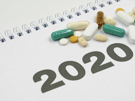 white calendar 2020 with various pills and copy space