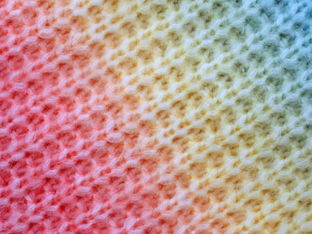 knitted cotton structure with a gradient from red to yellow to blue, close up of knitted cotton...