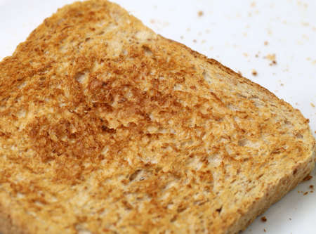 close up of toasted whole weat bread on white background