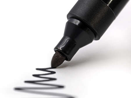 black permanent marker draws waves on white paper, close-upの写真素材