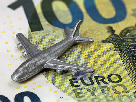 close up of miniatur airplane on 100 euro banknote, rising prices for flights or travel cost conceptの写真素材