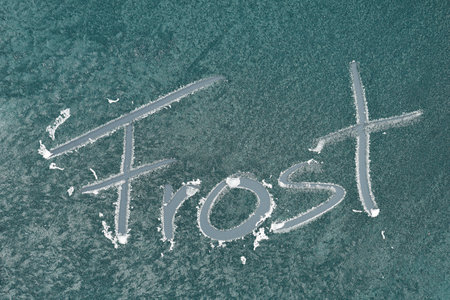 the word frost is written on the frozen windshield of a car, icy window with text frostの写真素材