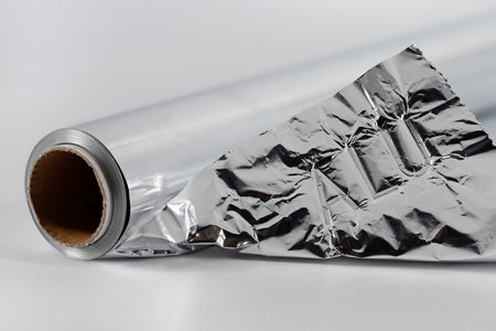Close-up of aluminum foil roll with embossed lettering, recycling aluminum in household concept imageの写真素材