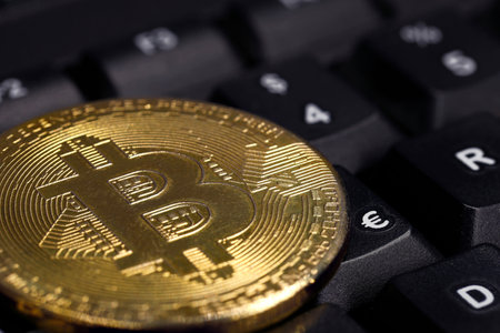 close up of golden Bitcoin on black keyboard with focus on euro symbol, Increasing importance of cryptocurrency in the euro areaの写真素材