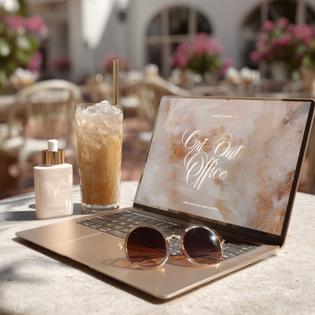 Laptop with coffee and sunglasses on a table in a summer cafeの素材