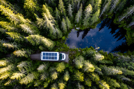 Aerial view of a car with solar panel in the forest.の素材