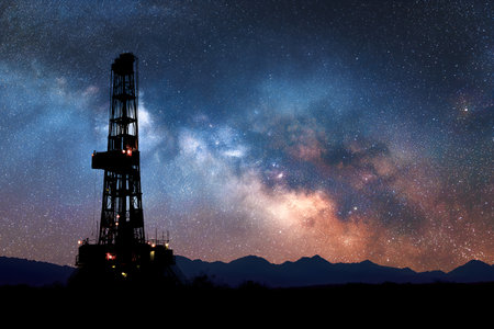 Oil drilling rig in the night sky with stars and milky wayの素材