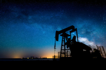 Oil pump in the night sky. Elements of this image furnished by NASAの素材