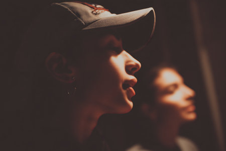 Portrait of a beautiful girl in a cap and a baseball capの素材