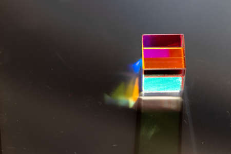 Colored square crystal with a rainbow on a substrate in close-upの写真素材
