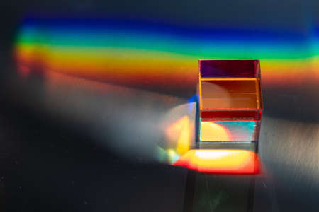 Colored square crystal with a rainbow on a substrate in close-upの写真素材