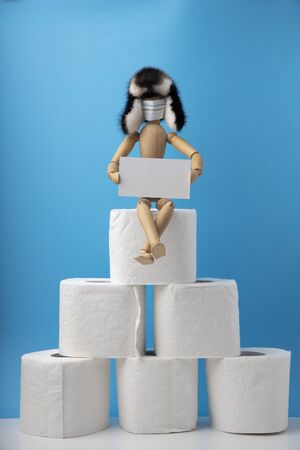 A man sits on the toilet paper rolls.の写真素材