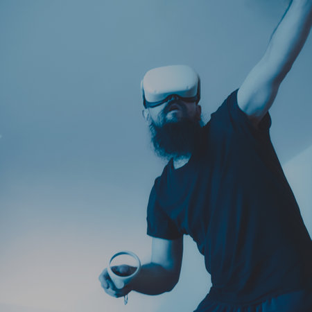 young man with a long beard and a mustache on the face of a virtual reality headset holding a cup of coffee in his handの写真素材