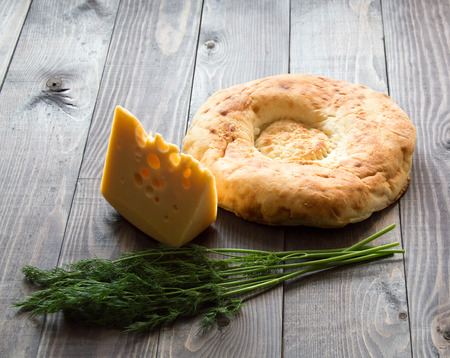 Delicious breakfast bread, cheese and dill on wooden table.の写真素材