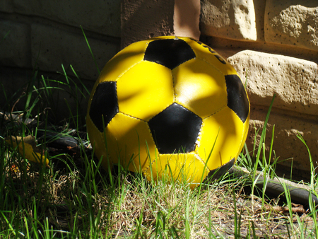 ball yellow and black color is designed for playing footballの写真素材