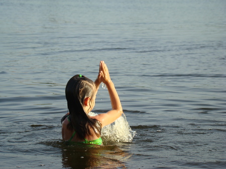 child bathing in the river splash and learn to swim