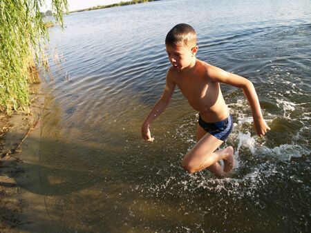 children swim and having fun in the riverの写真素材