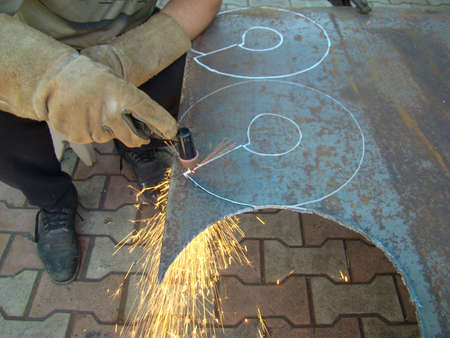 hand-held plasma cutting machine during close-up operationの写真素材