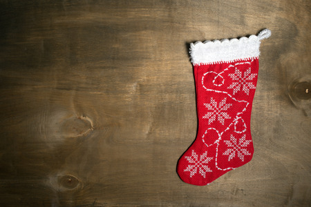 Handmade christmas stocking on wood background