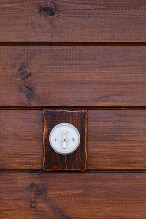 Retro light switch on wooden background
