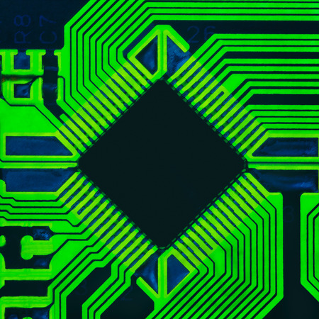 Abstract photo of an electrical board with a microprocessor in the centerの写真素材