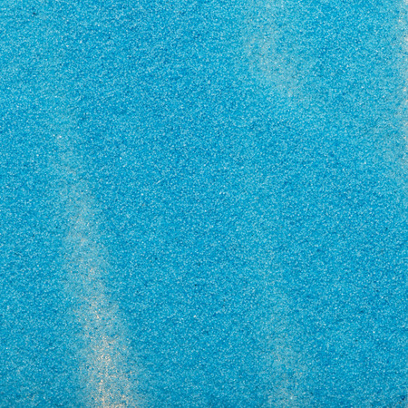 The texture of blue sand. Macro shot of small blue sand scattered over the surfaceの写真素材