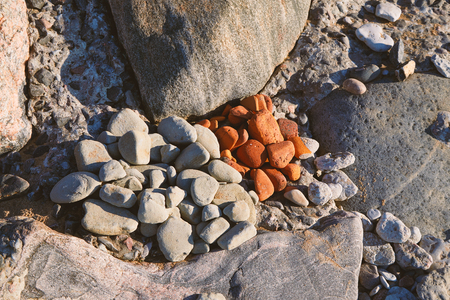 Two heaps of sea pebbles stacked together on a stone beachの写真素材
