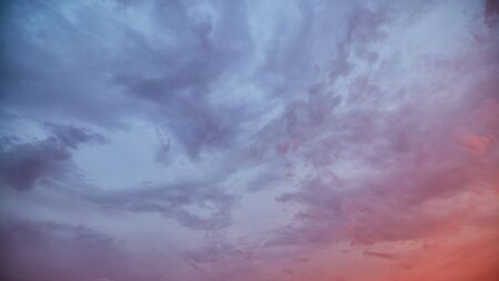 Dramatic sky at sunset with clouds lit by the setting sun