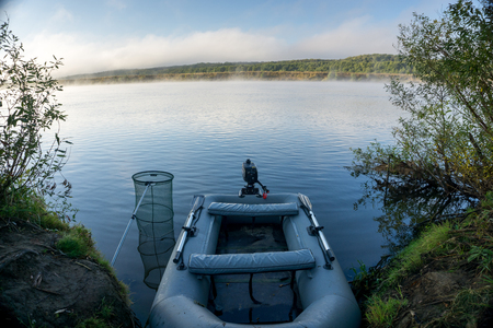 action afishing on the river, boat on the waterの写真素材