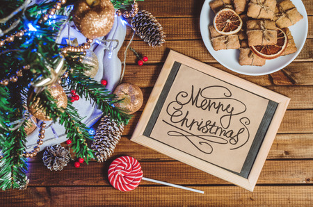 Christmas tree, toys and gifts and a card that says "Merry Christmas" top viewの写真素材