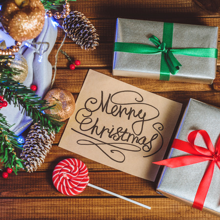 Christmas tree, toys and gifts and a card that says "Merry Christmas" top viewの写真素材