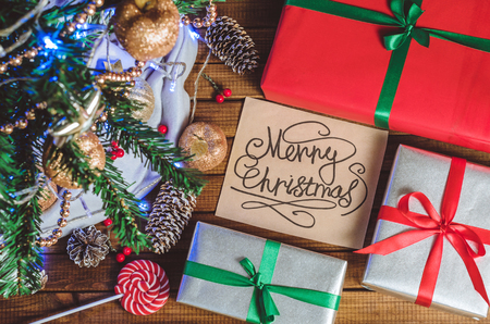 Christmas tree, toys and gifts and a card that says "Merry Christmas" top viewの写真素材